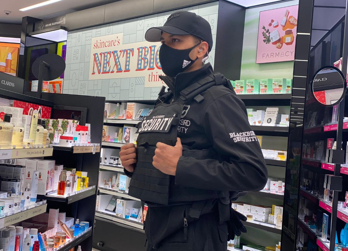 Uniformed Blackbird security guard in retail location