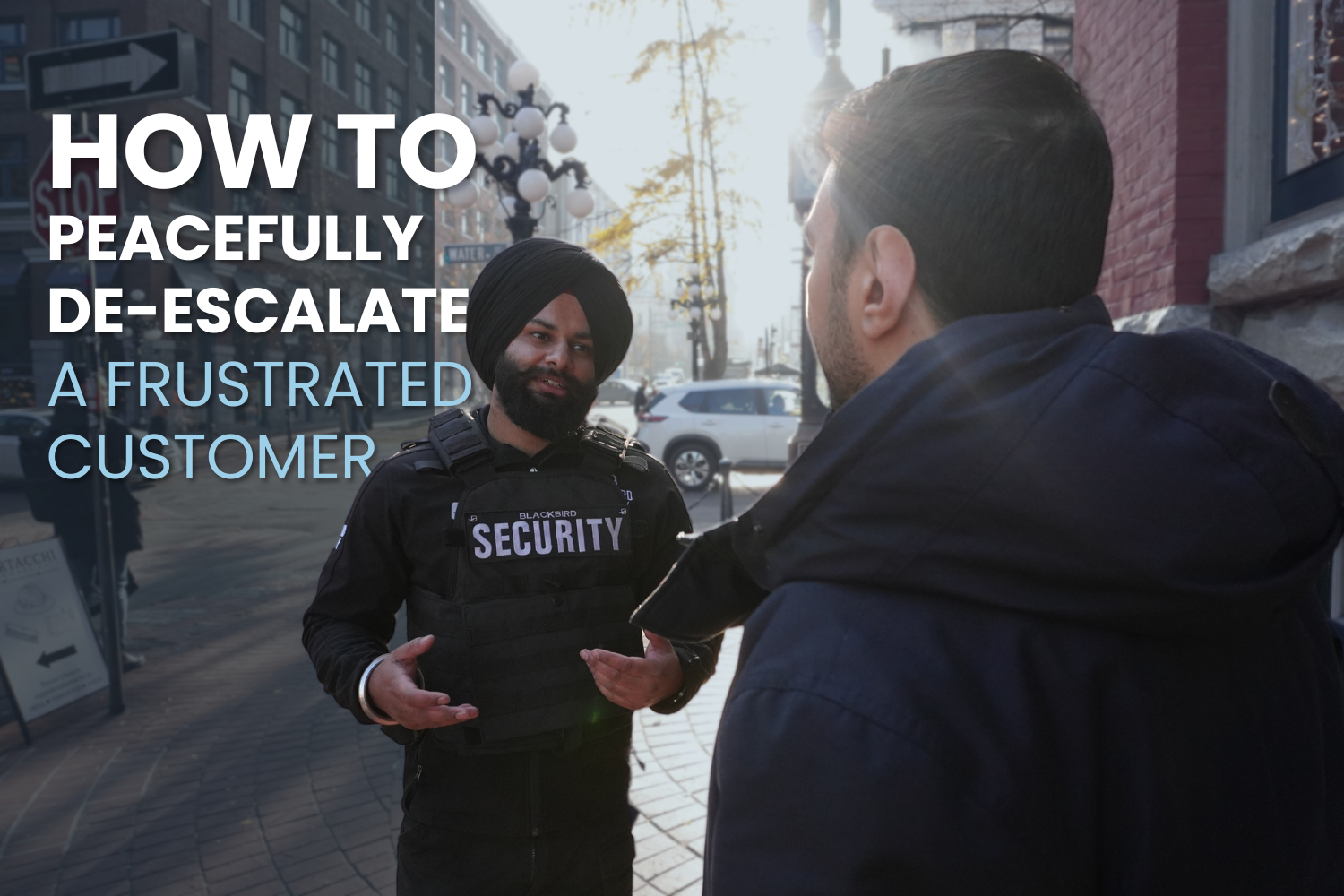 Male Blackbird Security guard interacting with man on street