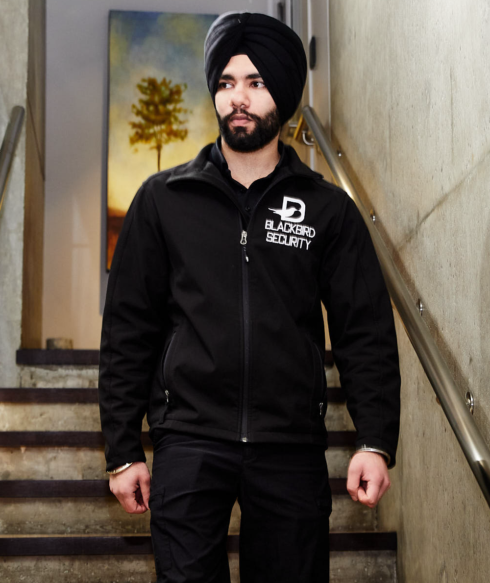 Blackbird security guard walking down stairs