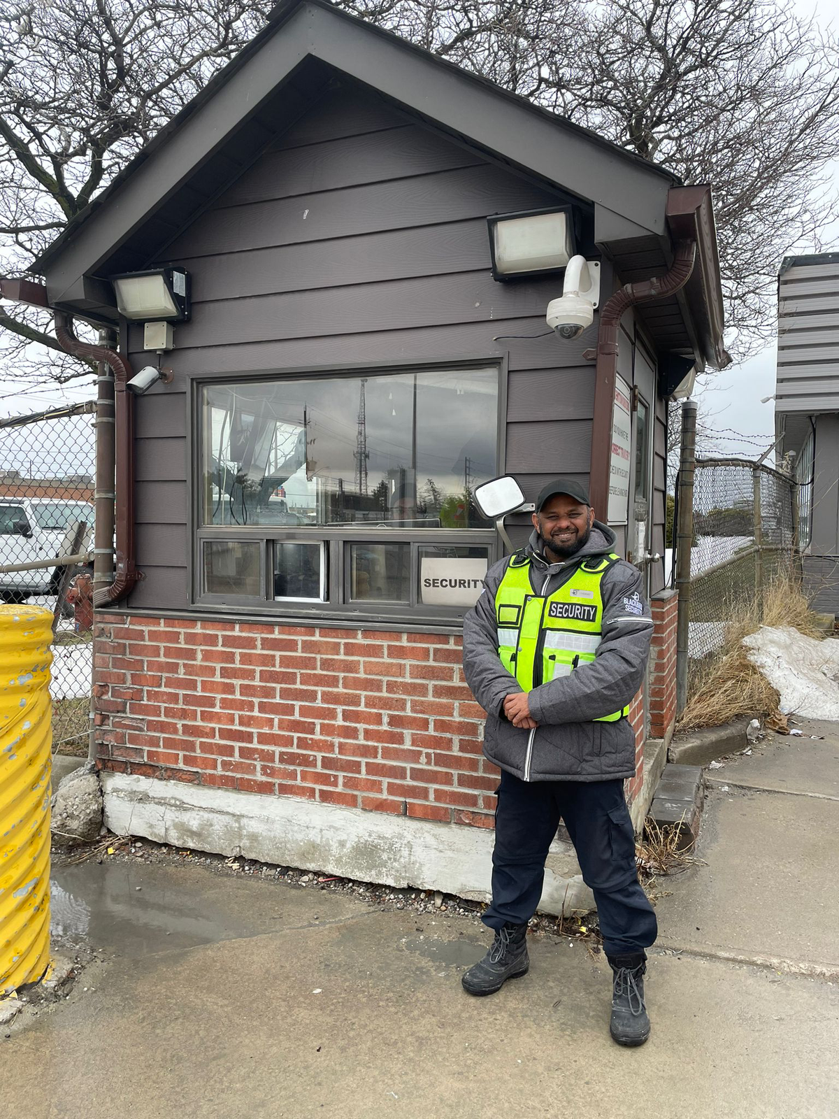 Blackbird security guard with high-vis vest at security gatehouse