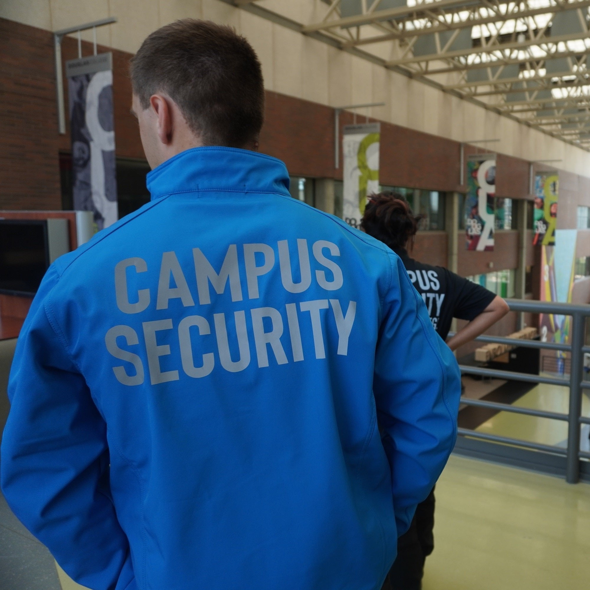 Two Campus security guards standing in foyer of Douglas College
