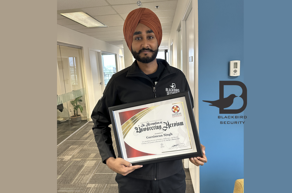 Blackbird security guard holding award in frame