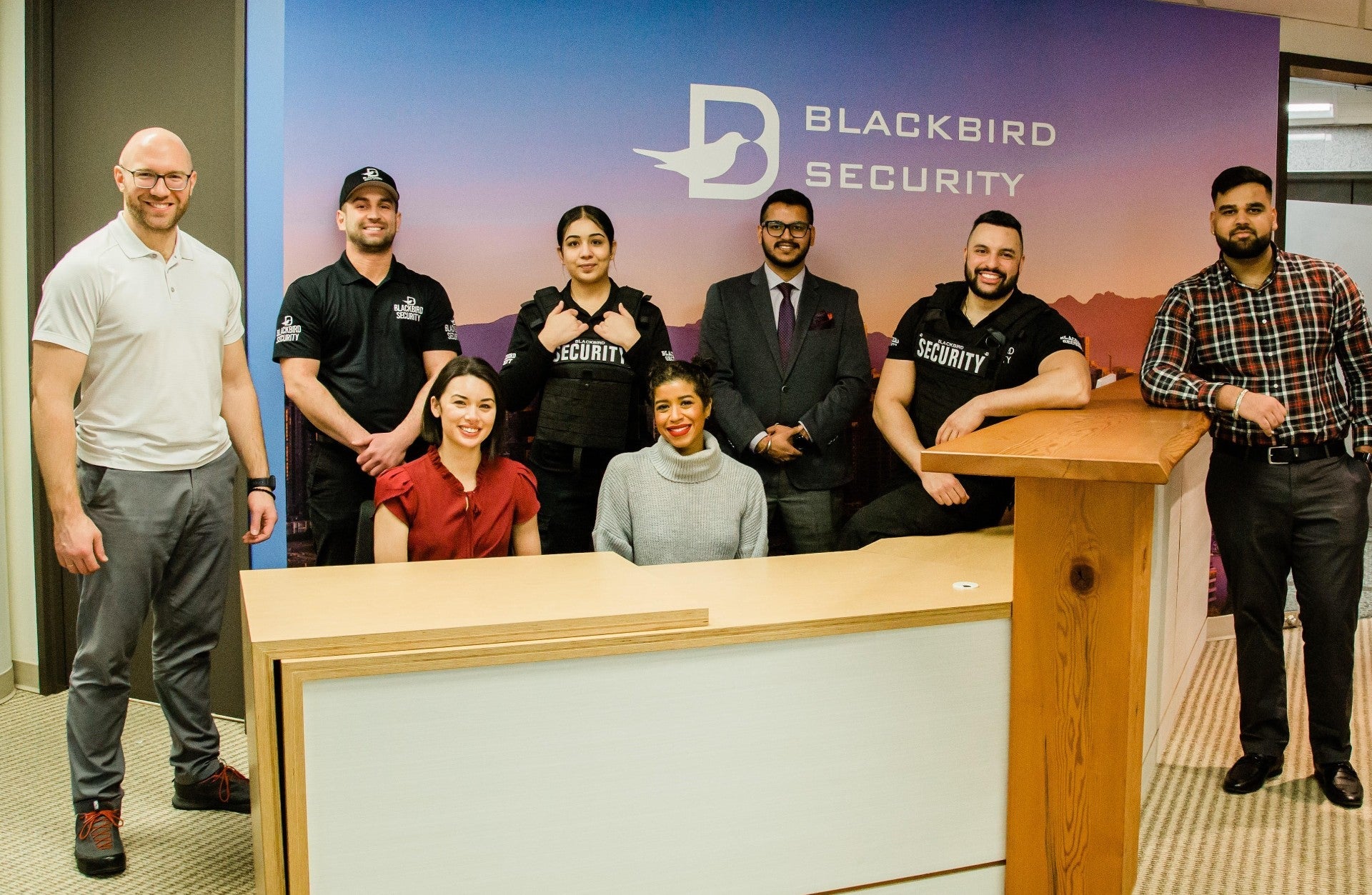 Group of Blackbird security employees standing in front of reception desk