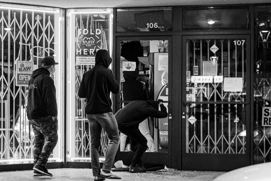 Three people breaking into Commercial retail store