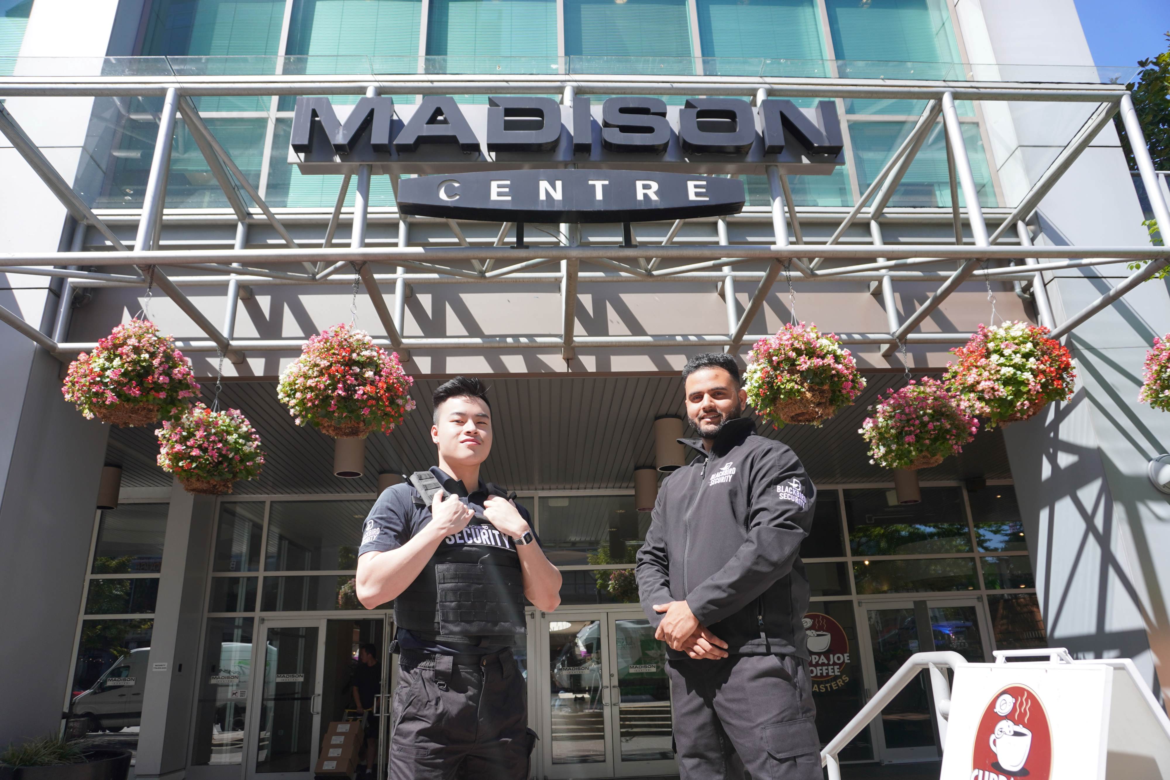 Two Blackbird security guards in front of shopping mall