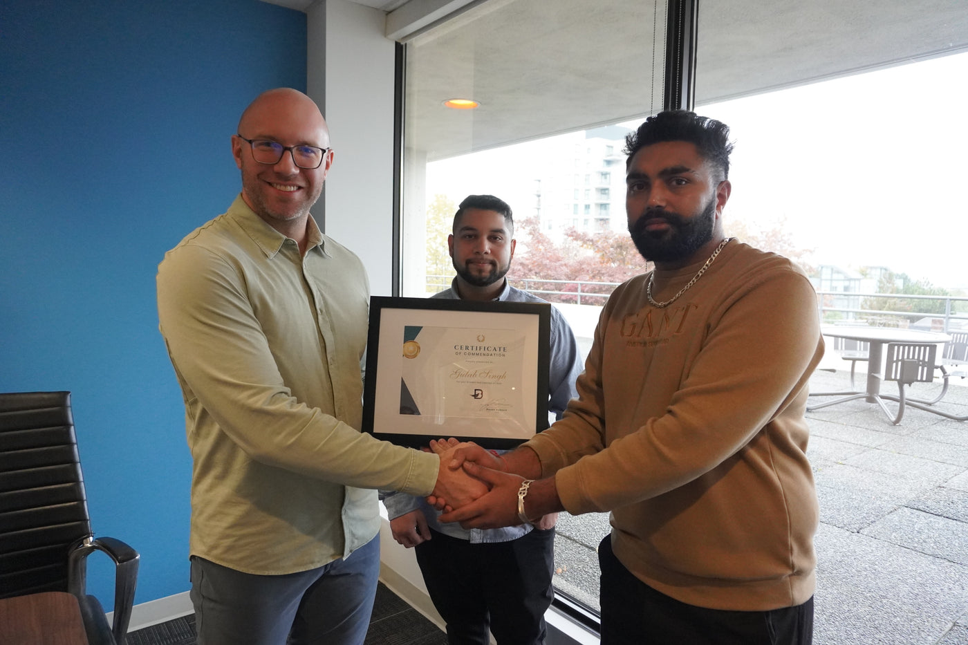 Blackbird Security guards shaking hands and receiving a certificate of appreciation for acts of bravery