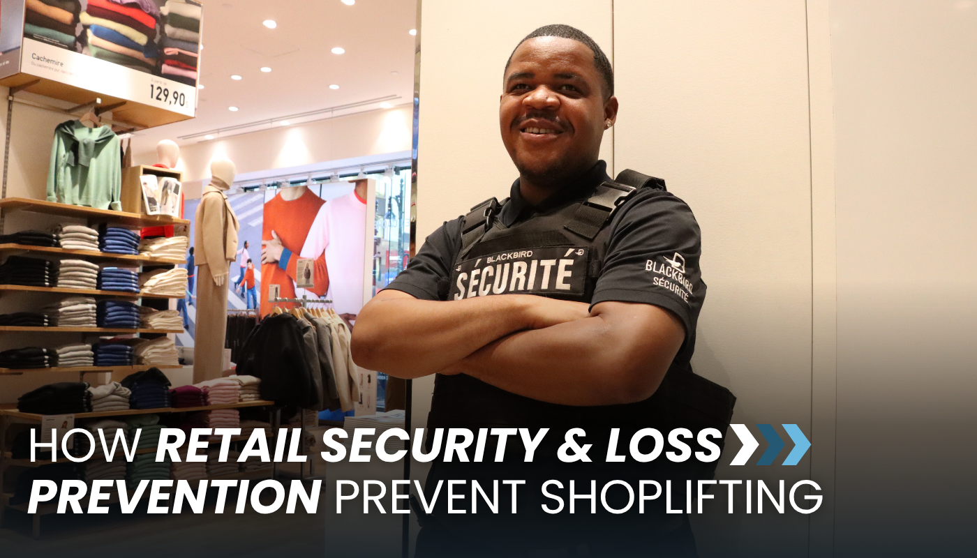 A security guard in a clothing store poses for the camera