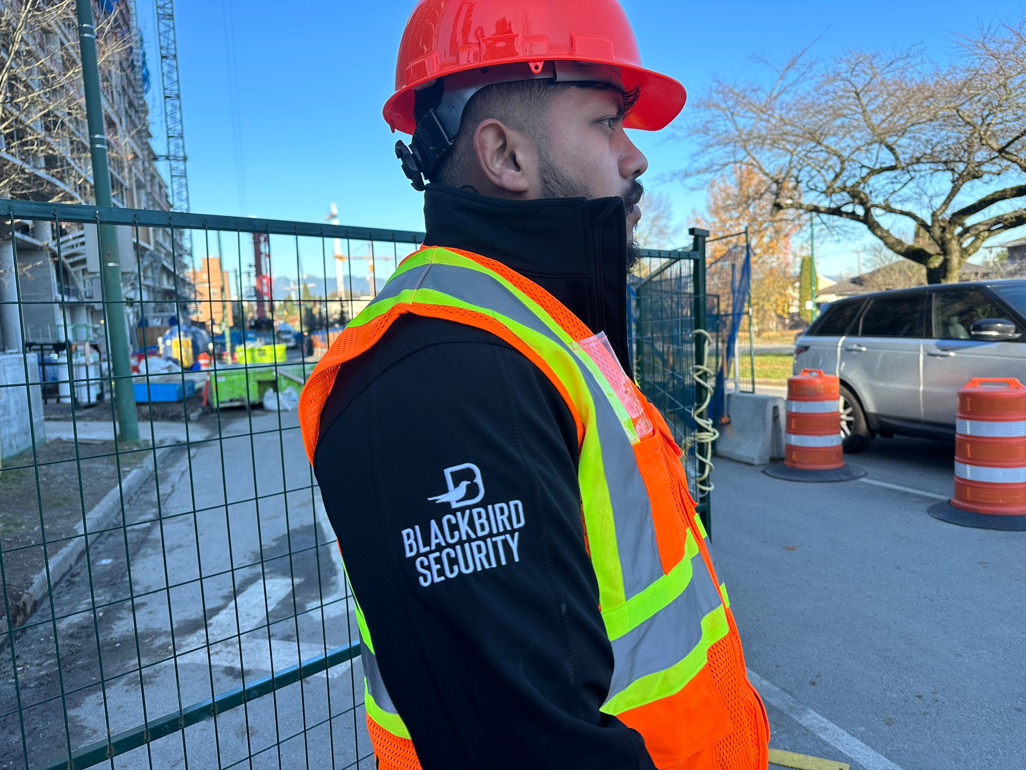 Blackbird security guard with high-vis vest at security entrance to construction site