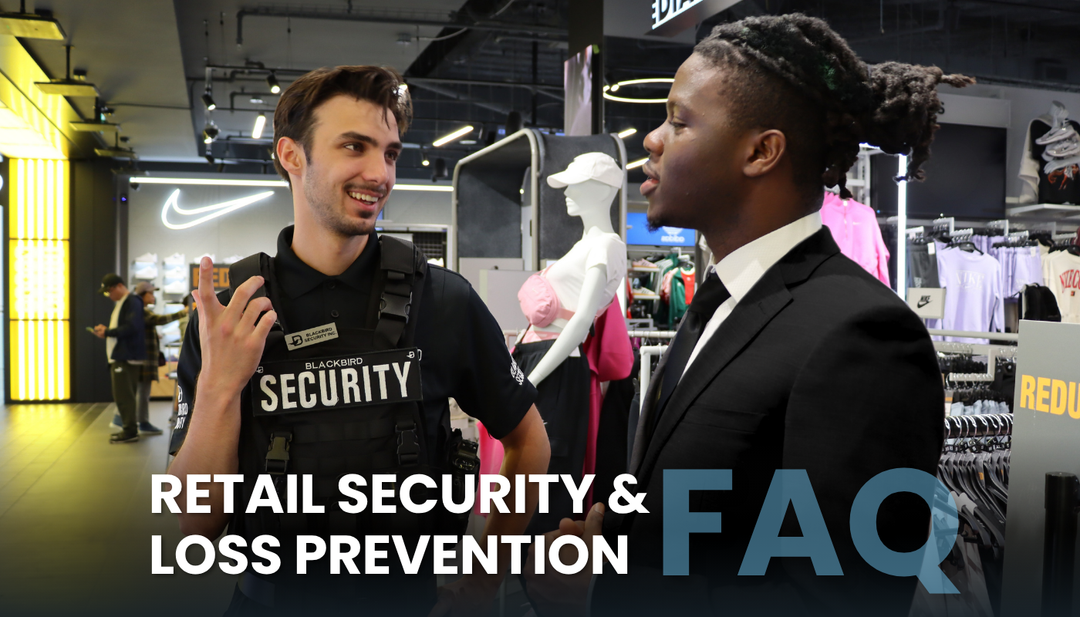 Two security guards stand inside a sports clothing store with the Nike logo in the background.