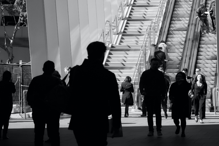 people walking up stair and riding escalator