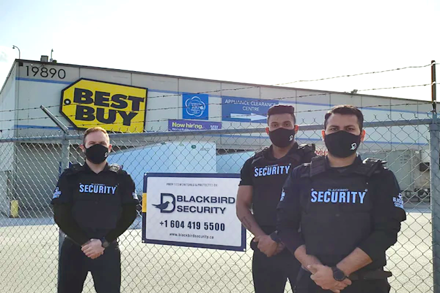 Uniformed security guards outside the Best Buy warehouse in Langley.