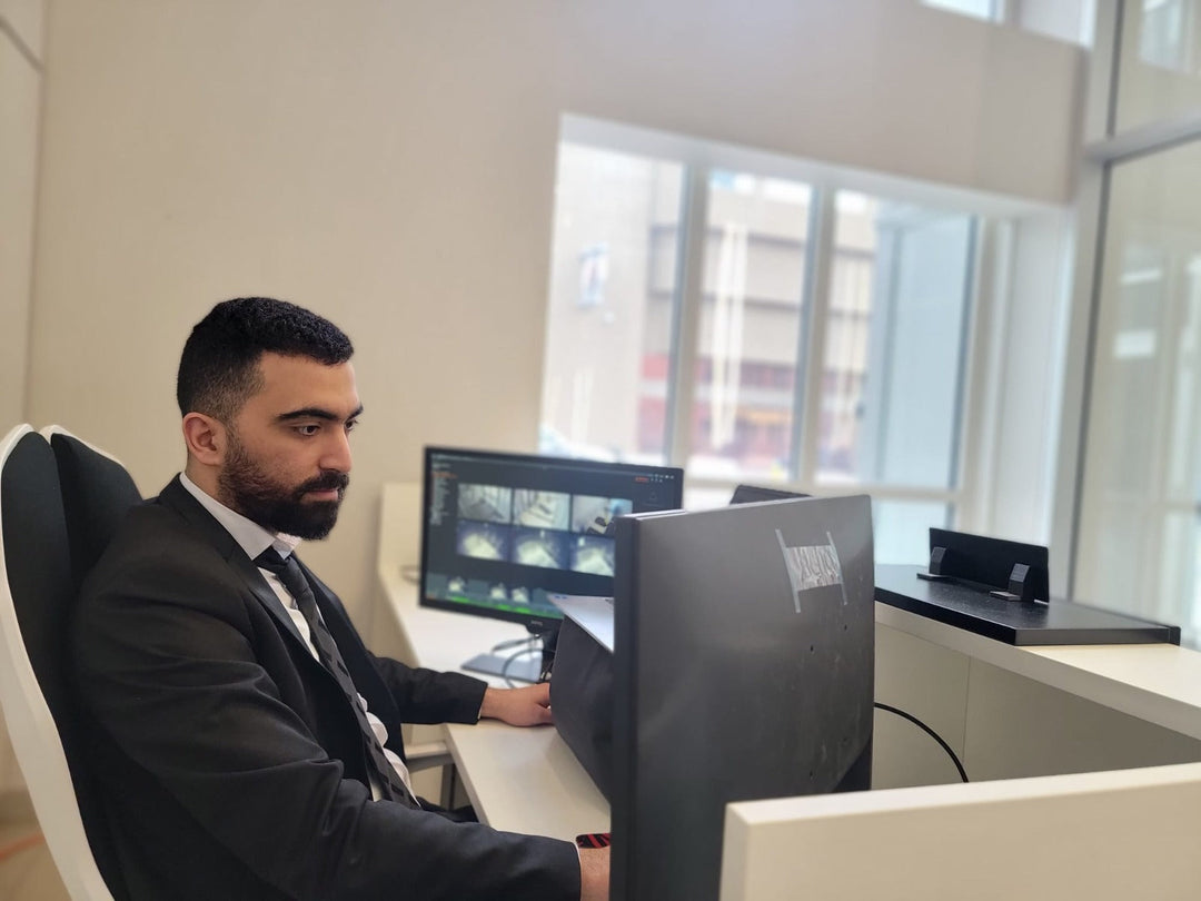 Blackbird security guard sitting at reception desk in front of screens