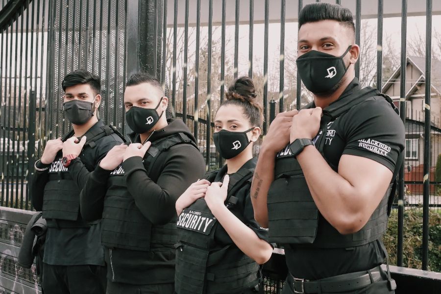 Four Blackbird security guards with masks on