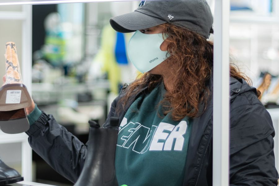 person in mask looking at item in retail store