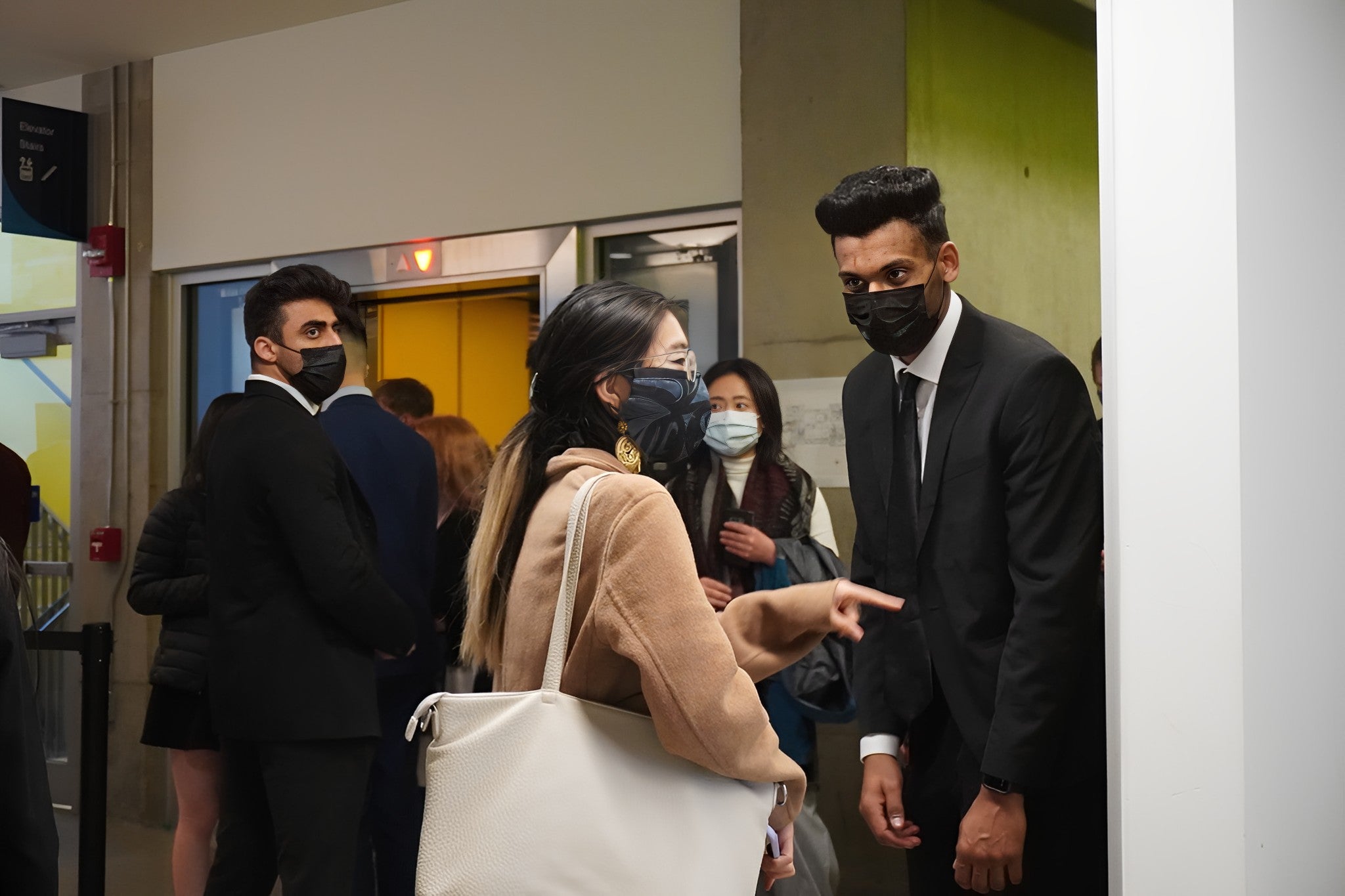 Two Blackbird Security guards on duty at a conference, surrounded by conference attendees