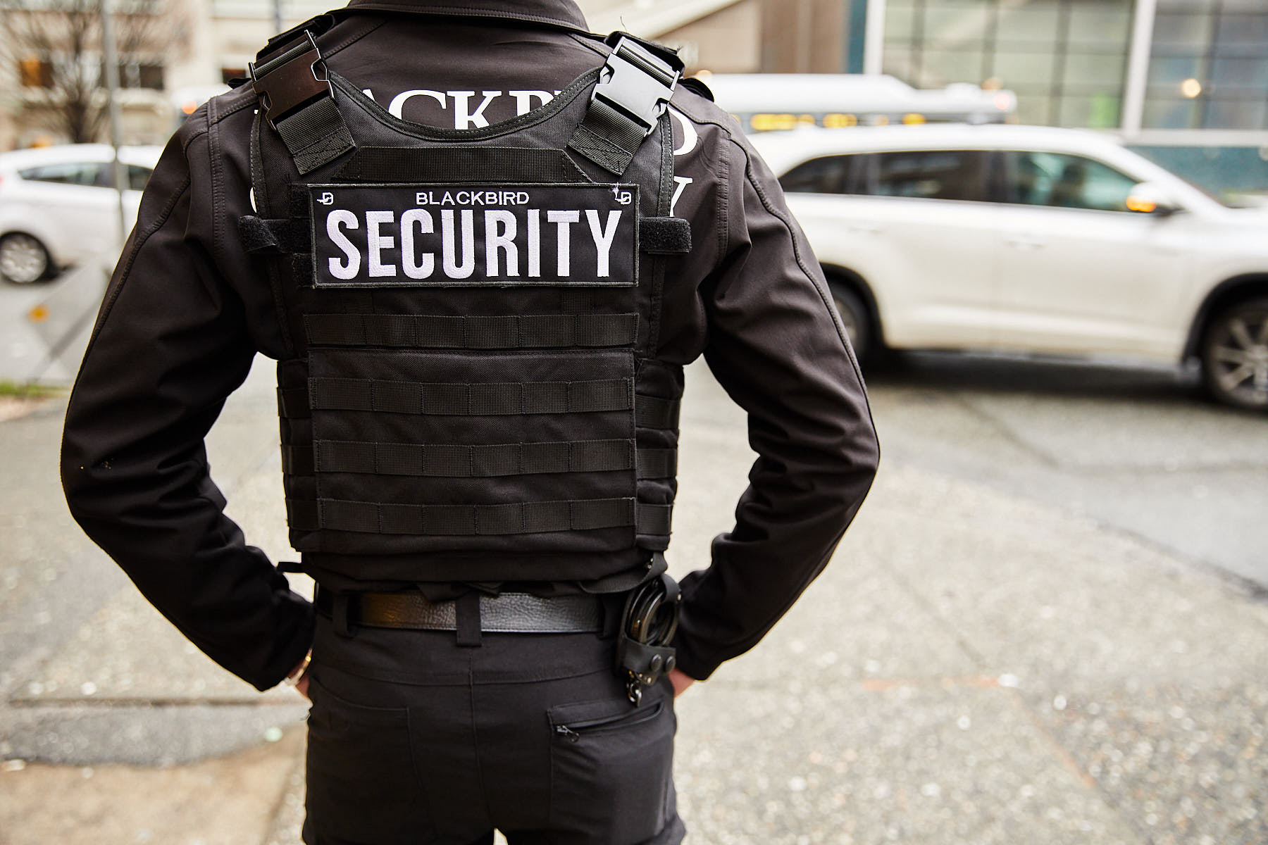 Uniformed Blackbird Security guard standing outside on a street