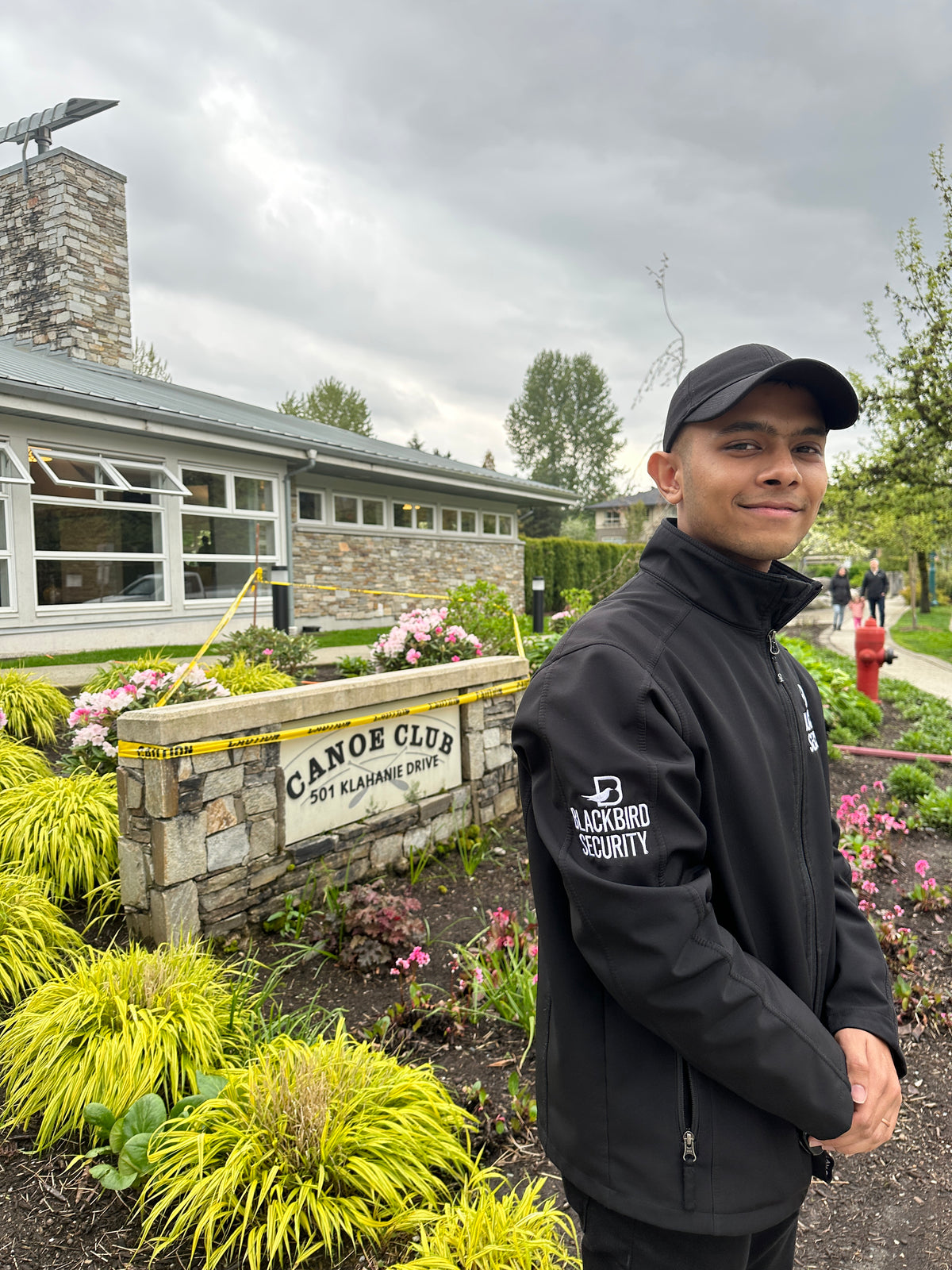 Blackbird security guard stands outside of the Canoe Club building