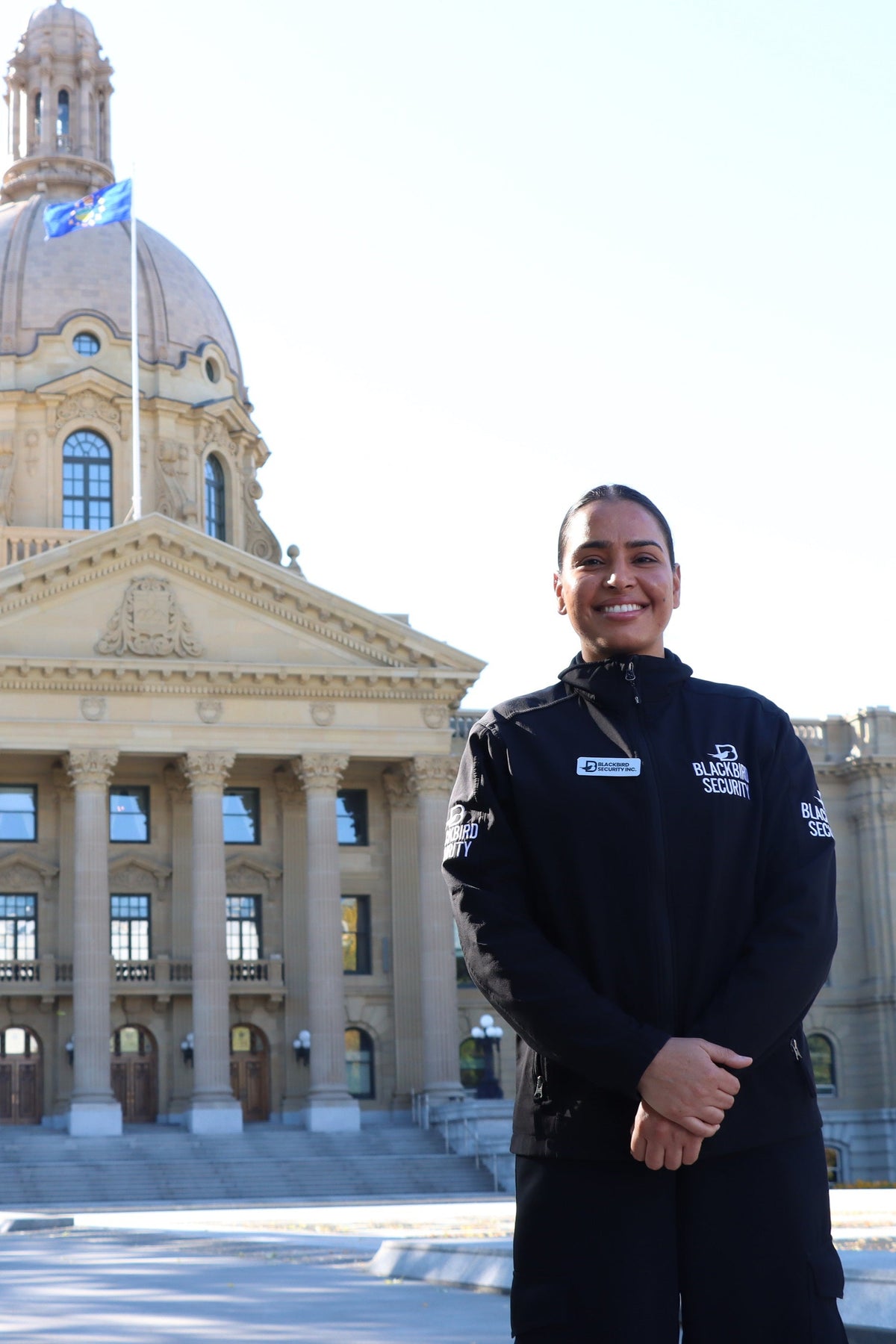 Blackbird Security Uniform Guard standing in front of the Alberta Legislative Building