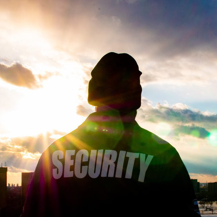 Security Guard standing in sunset. Photo supplied by: Unsplash